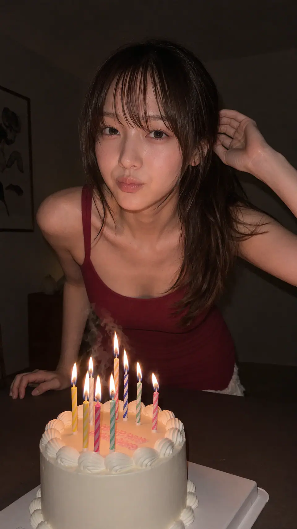 Riho leaning over a birthday cake